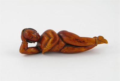 Appraisal: A Chinese ivory model of a reclining woman her hair