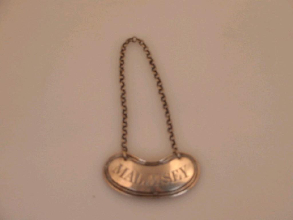 Appraisal: A George III silver decanter label of kidney shaped design