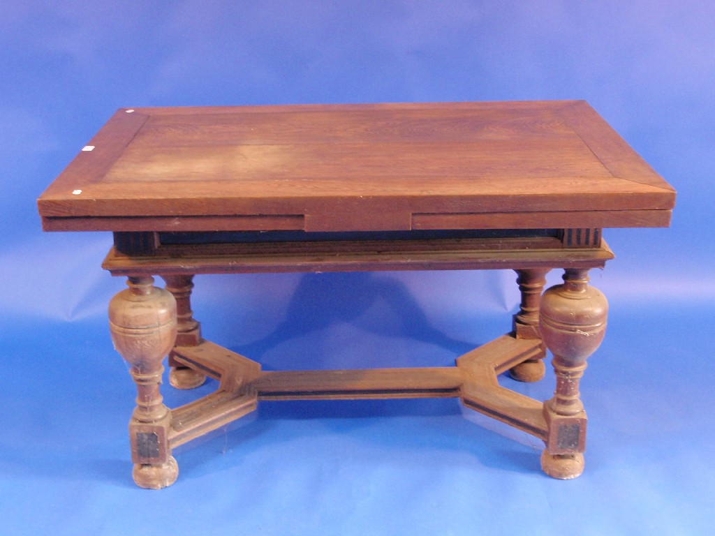 Appraisal: A continental oak drawer leaf table raised on four bulbous