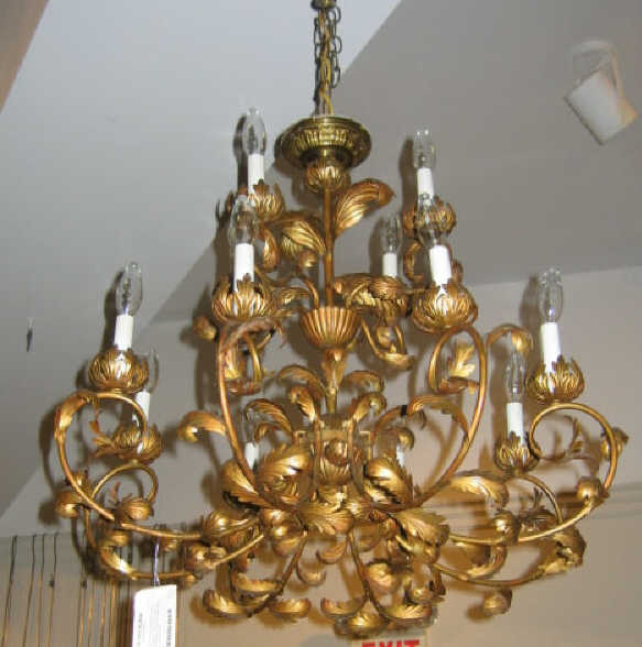 Appraisal: CONTINENTAL TWELVE-LIGHT GILT METAL CHANDELIER Two-tier foliate scroll arm topped