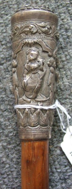 Appraisal: A bamboo walking stick probably Burmese with silver pommel moulded