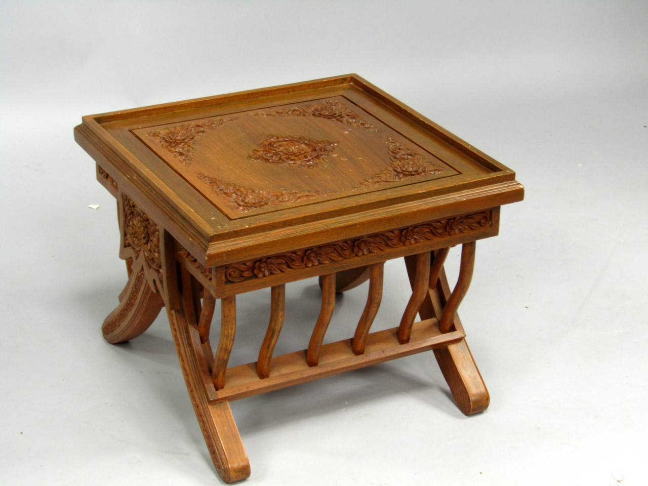 Appraisal: An Indonesian carved hardwood square occasional table carved with floral