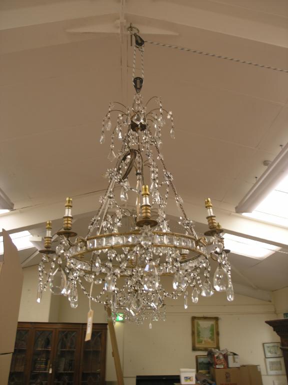 Appraisal: A pair of brass and cut glass chandeliers each with