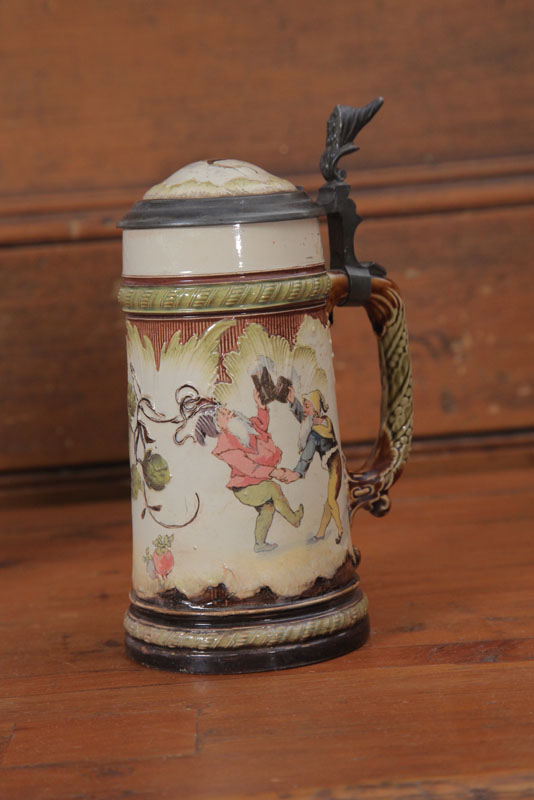 Appraisal: METTLACH STEIN Liter With pub scene embossed foliate decoration and