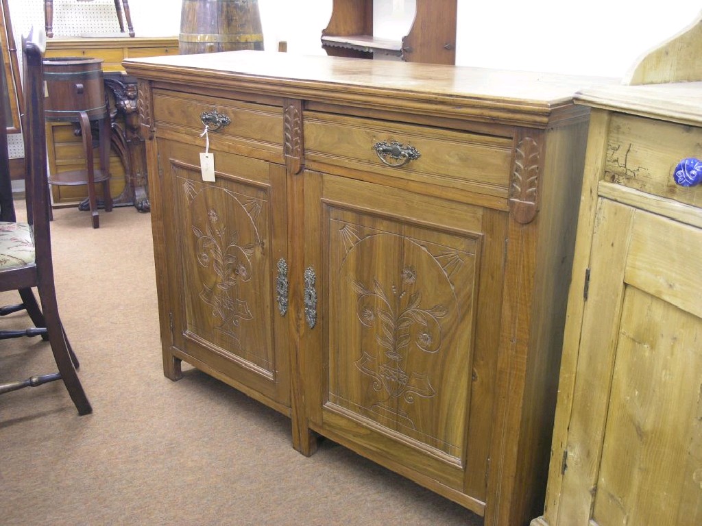 Appraisal: A late Victorian walnut side cupboard two drawers above a