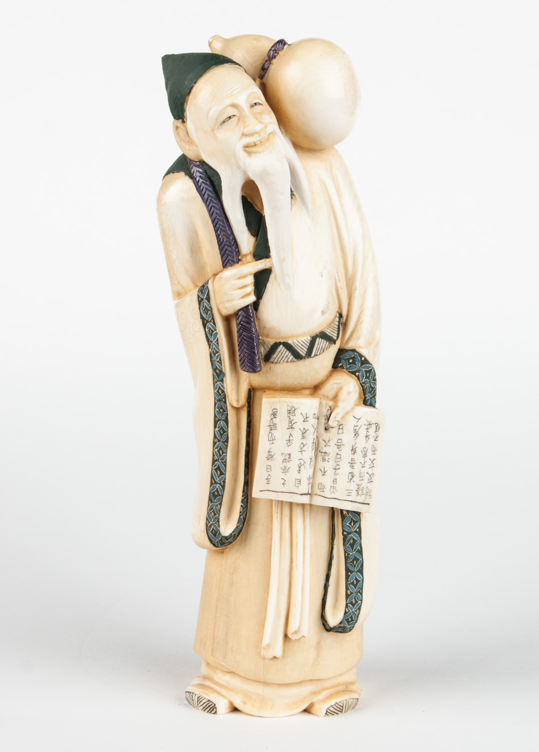 Appraisal: Japanese carved ivory deity figure polychrome gilt and ink-highlighted figure