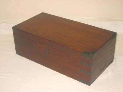 Appraisal: A TEAK FOLDING WRITING SLOPE with brass banding hinged top