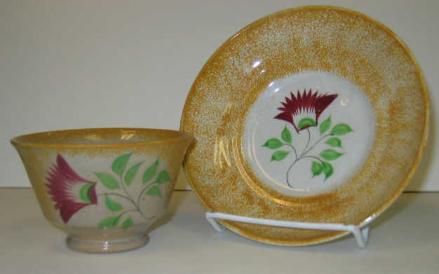 Appraisal: ENGLISH SPATTERWARE Yellow spatter handless cup and saucer with thistle