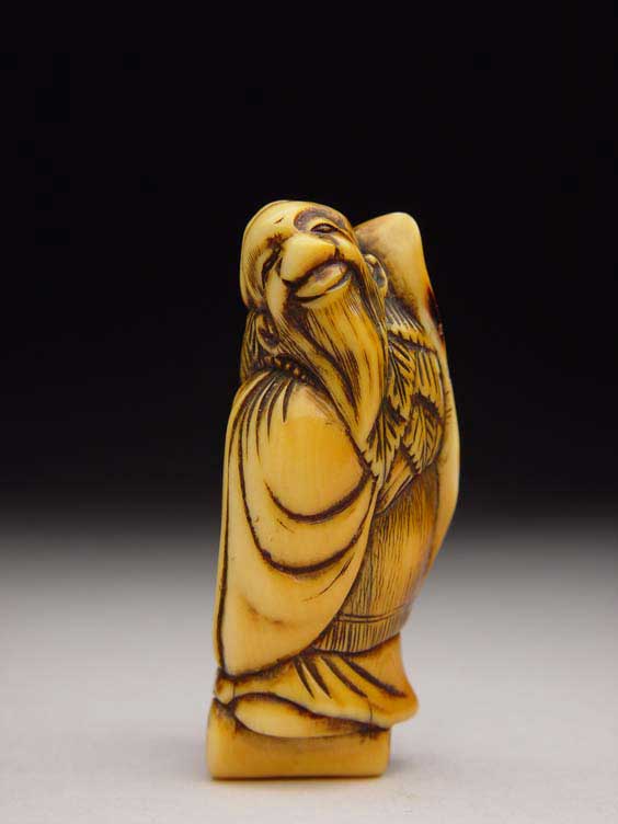 Appraisal: ANTIQUE IVORY NETSUKE Antique stained and carved ivory netsuke of