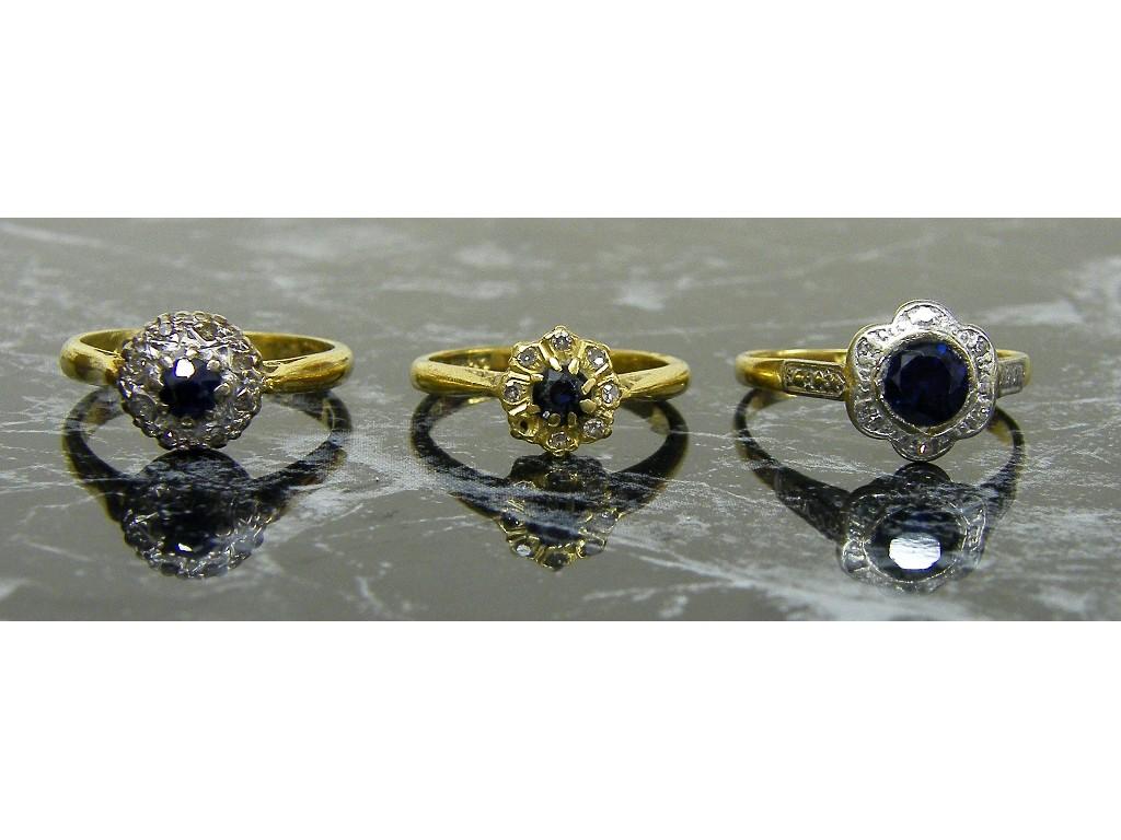 Appraisal: Three similar ct circular sapphire and diamond cluster rings gm