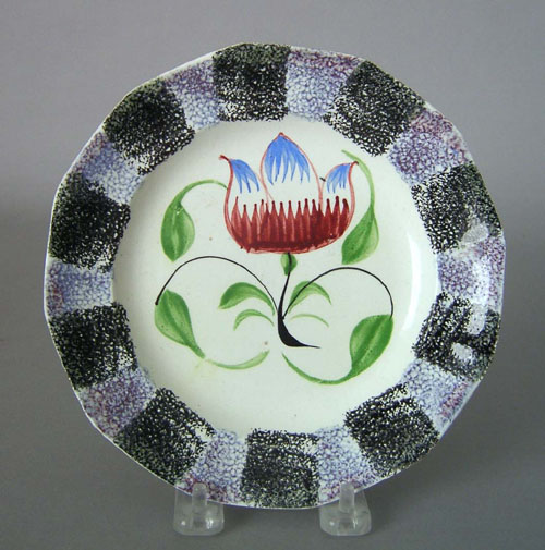 Appraisal: Purple and black rainbow spatter plate th c with tulip