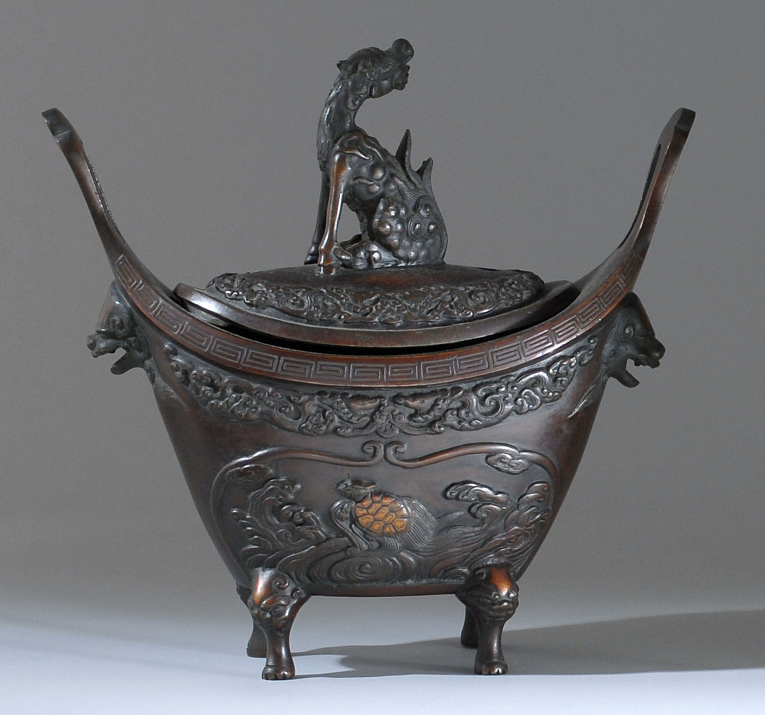 Appraisal: COPPER-BRONZE INCENSE BURNER Meiji PeriodIn boat form with lion's-head handles