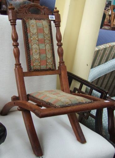 Appraisal: A Victorian oak child's travelling chair with turned supports and