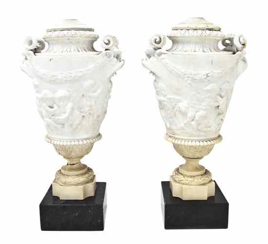 Appraisal: A Pair of Parianware Urns of tapering form with opposing