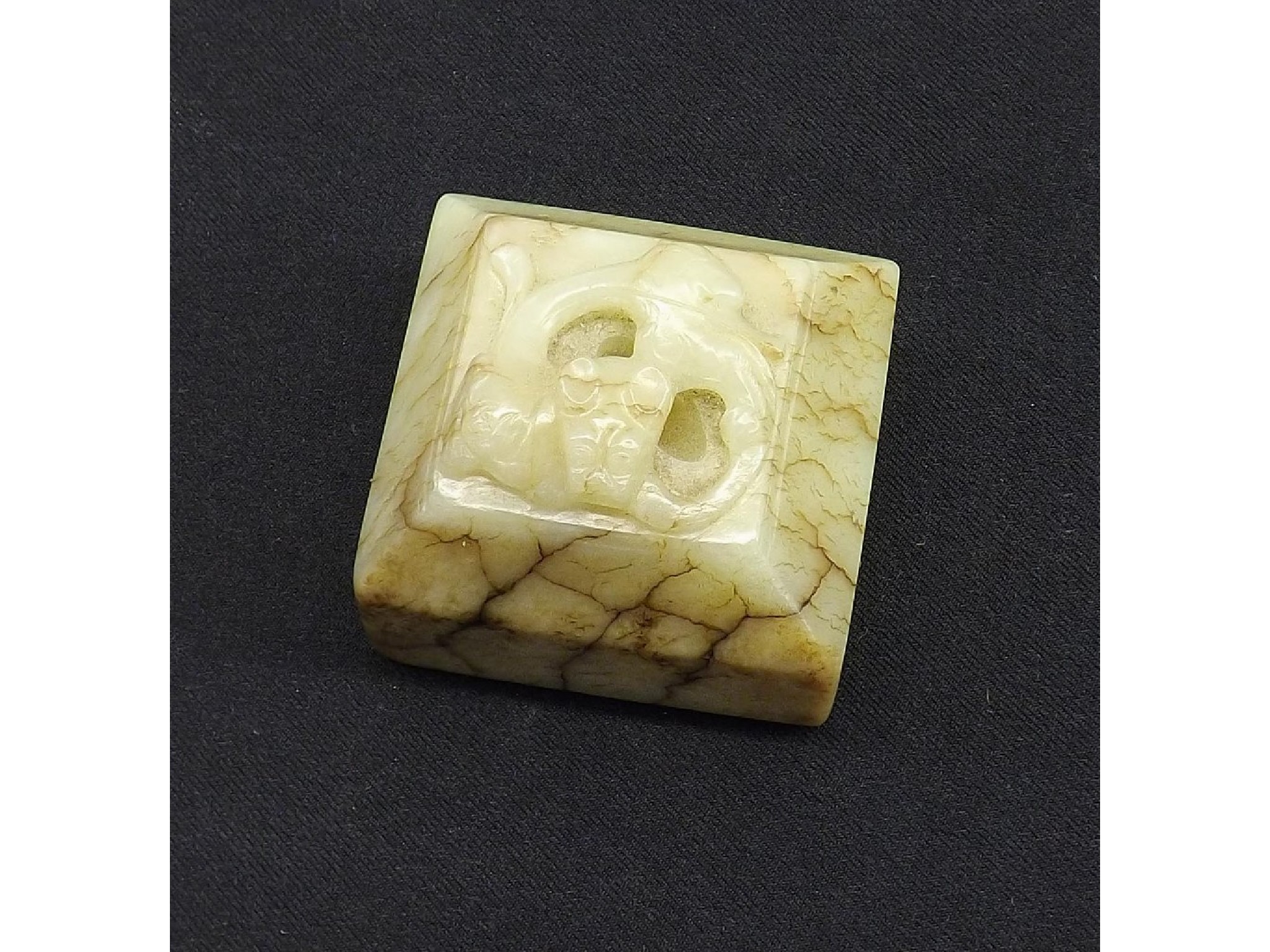 Appraisal: Celadon and brown streaked square canted jade seal surmounted by