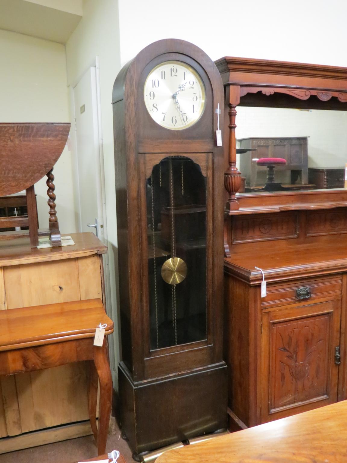 Appraisal: A 's dark oak longcase clock with circular silvered dial