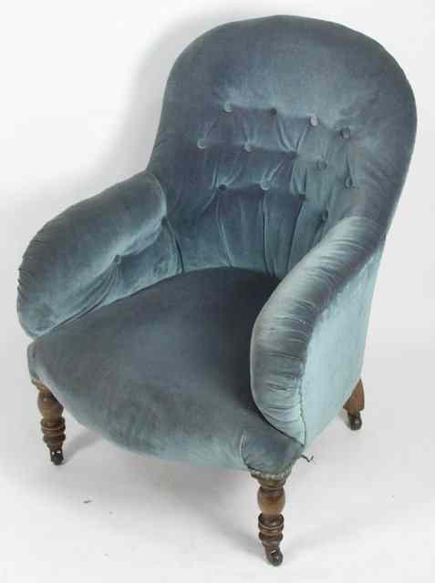 Appraisal: A Victorian upholstered armchair with deep button back on turned