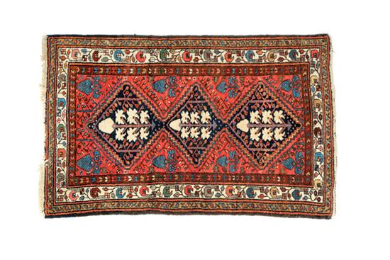 Appraisal: ORIENTAL RUG Twentieth century Hamadan Repeating ivory medallions with blue