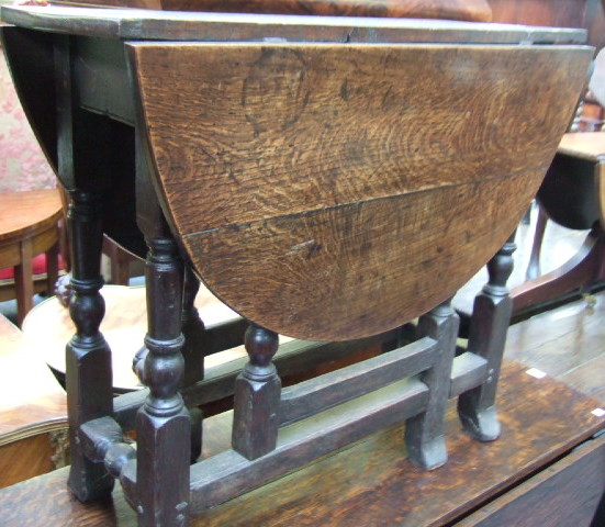 Appraisal: A th century oak oval gateleg table resting on block