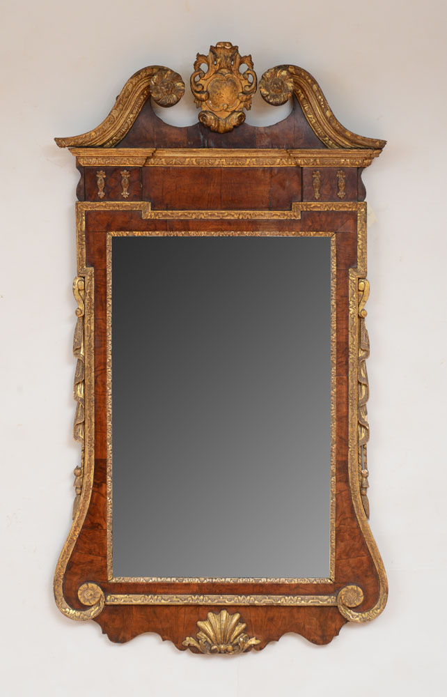 Appraisal: FINE GEORGE II WALNUT AND PARCEL-GILT MIRROR The upright plate