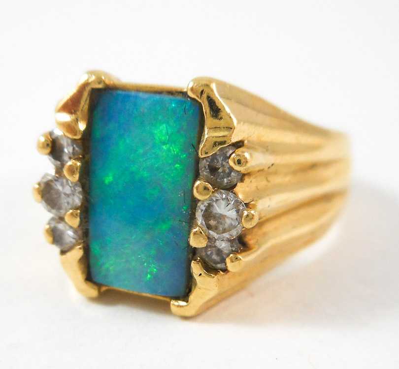 Appraisal: OPAL DIAMOND AND FOURTEEN KARAT GOLD RING with three round-cut