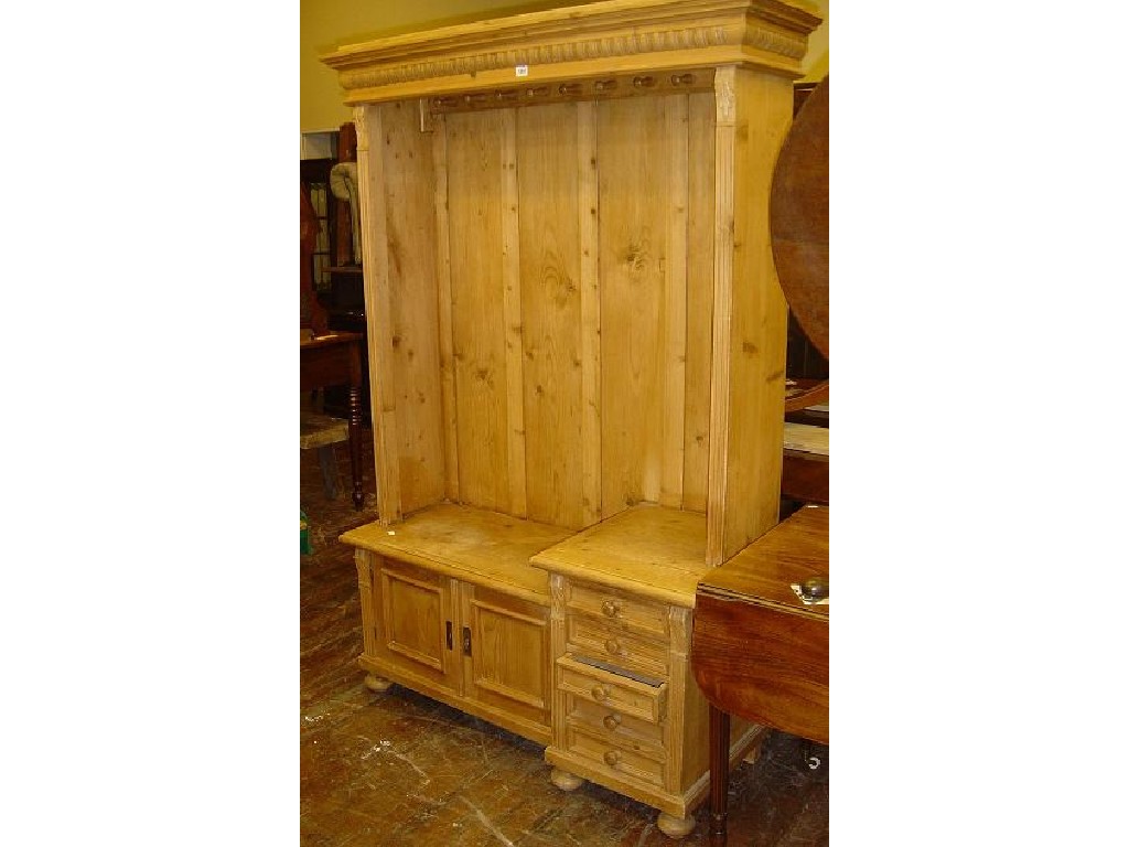 Appraisal: A continental stripped pine hall cupboard the lower section fitted