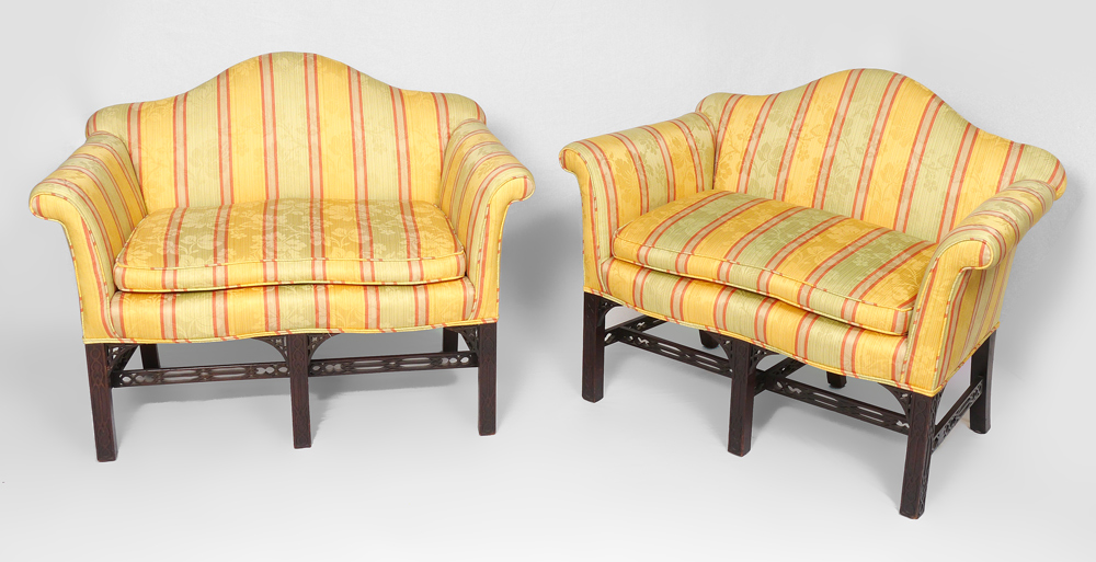 Appraisal: PAIR CHINESE CHIPPENDALE STYLE SETTEES Mahogany framed camel back rolled