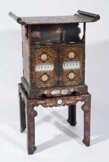 Appraisal: A JAPANESE BLACK LACQUER AND PORCELAIN INLAID CABINET on stand