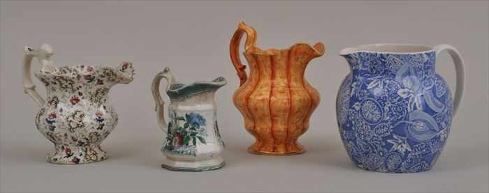 Appraisal: FOUR STAFFORDSHIRE MILK JUGS Including a faux bois baluster-form pitcher