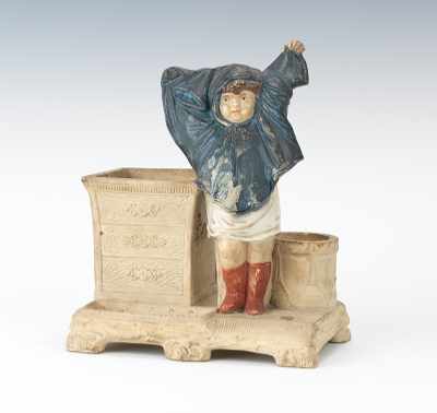 Appraisal: A Figural Match-Strike of a Child Pottery match strike and