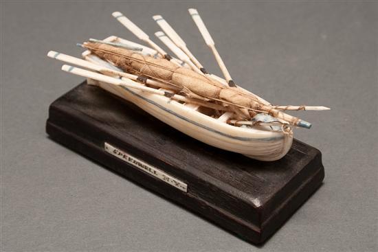 Appraisal: Miniature carved ivory whaling boat mounted on a wood base