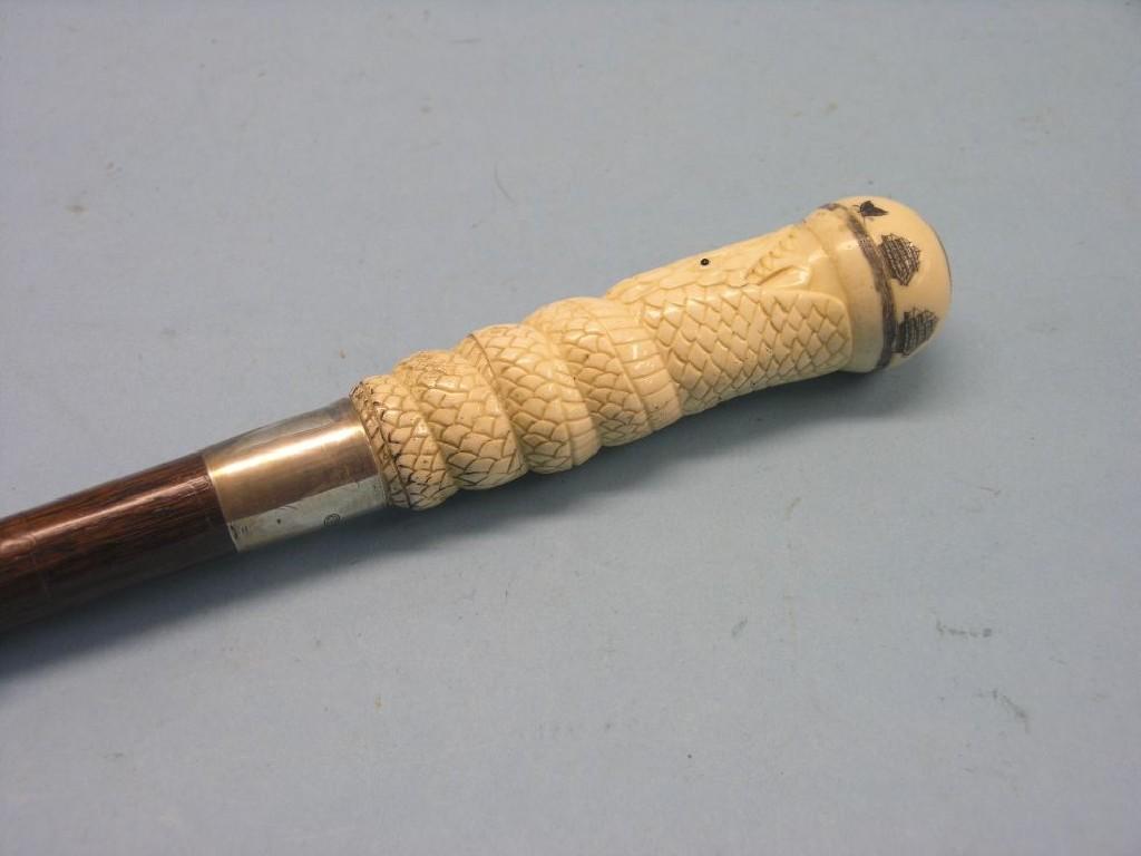 Appraisal: A silver-mounted novelty dual-purpose walking cane bone handle carved in