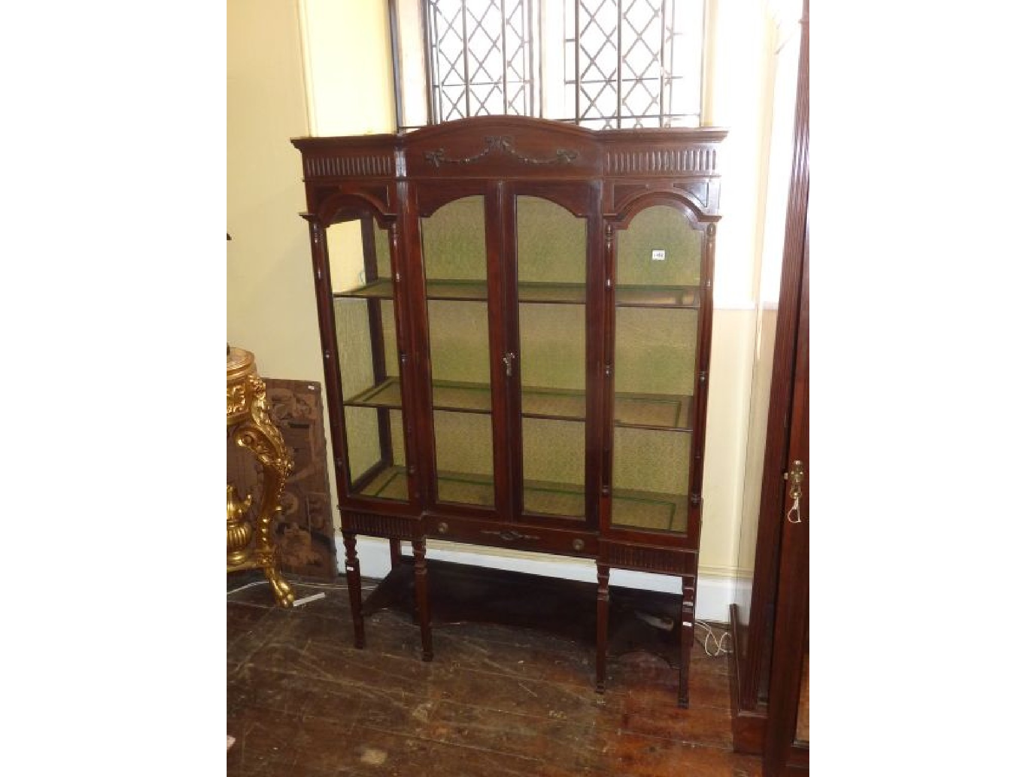 Appraisal: An Edwardian mahogany china display cabinet with three quarter length