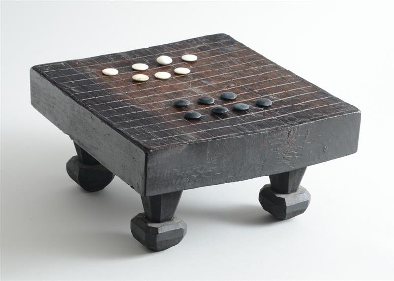 Appraisal: AFRICAN CARVED AND INCISED WOOD GAME BOARD The rectangular top