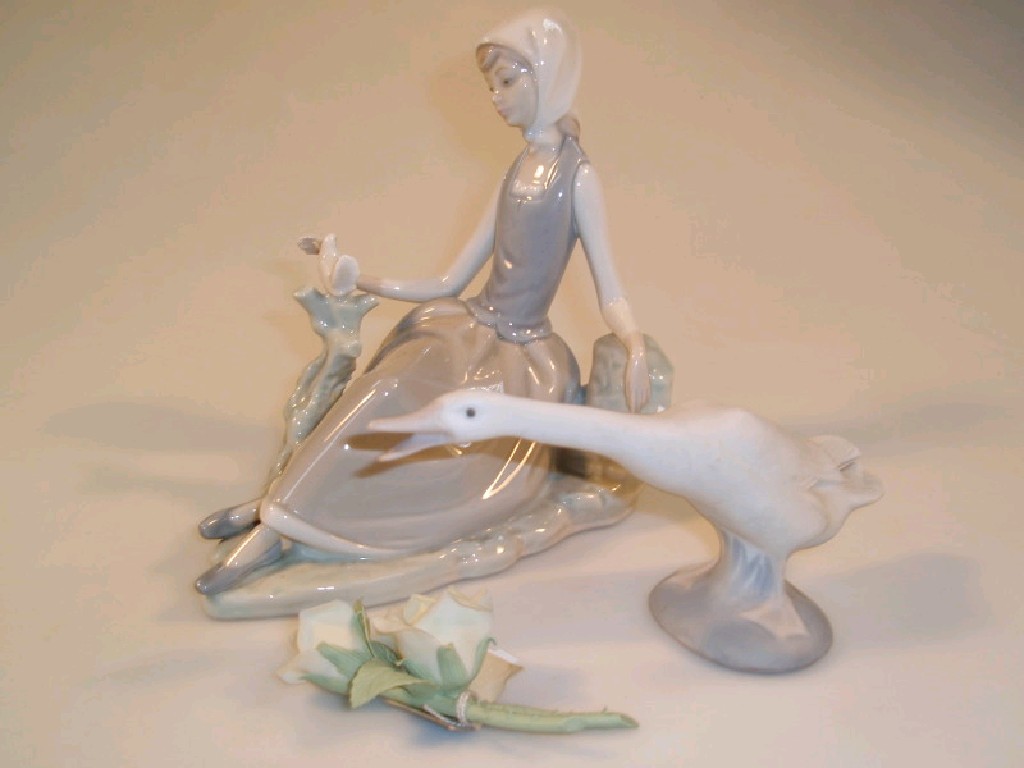 Appraisal: A Lladro porcelain figure of a young girl seated by