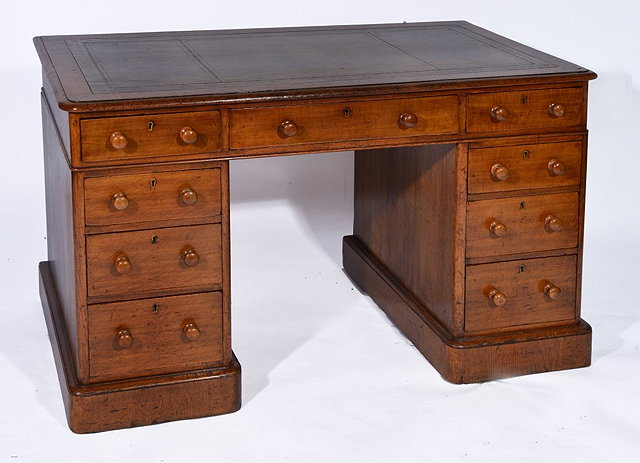 Appraisal: A VICTORIAN OAK PEDESTAL DESK with inset leather top fitted