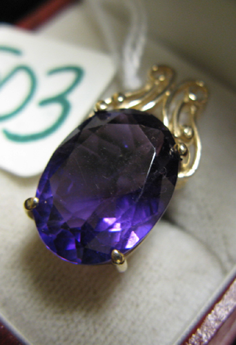 Appraisal: AMETHYST AND FOURTEEN KARAT GOLD PENDANT centering a large oval-cut