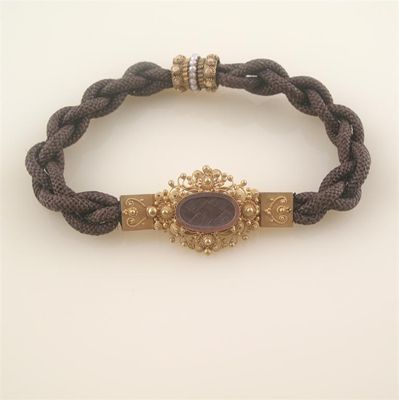 Appraisal: A Victorian plaited hair bracelet a gold cannetile clasp centred