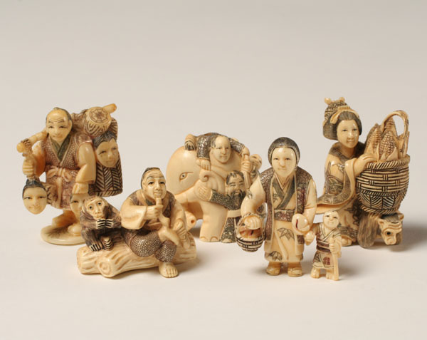 Appraisal: Japanese carved netsukes families peddlers and an elephant Tallest