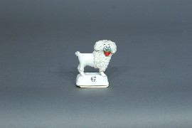 Appraisal: A pair of Staffordshire clipped poodles holding baskets in their