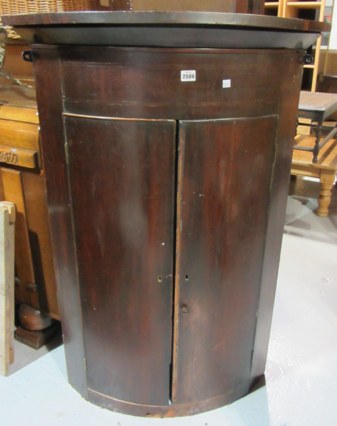 Appraisal: A th century bowfront corner cabinet