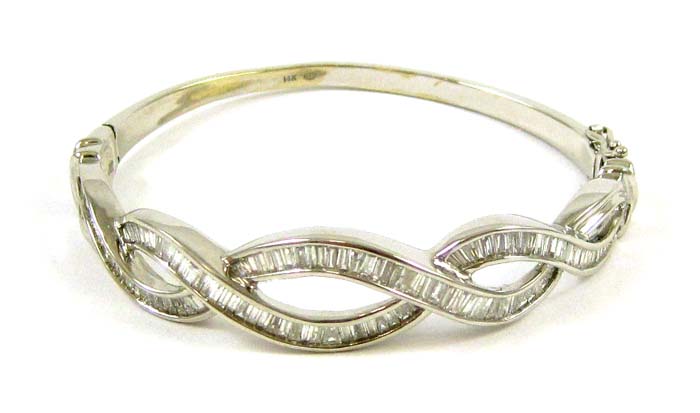 Appraisal: DIAMOND AND FOURTEEN KARAT WHITE GOLD BANGLE with baguette-cut channel