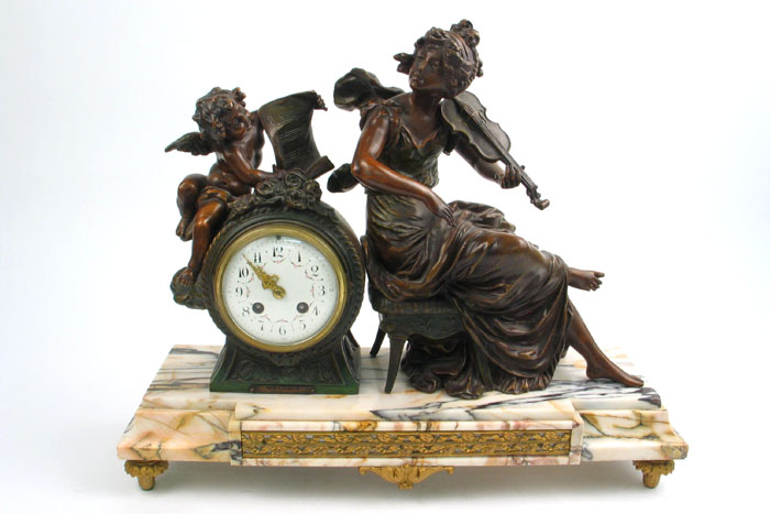 Appraisal: A FRENCH FIGURAL MANTEL CLOCK The stepped and striated footed