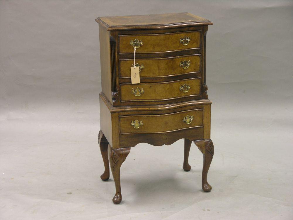 Appraisal: A reproduction burr walnut veneered bedside chest serpentine fronted with