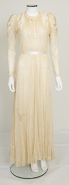 Appraisal: An early th Century cream lace wedding dress with satin