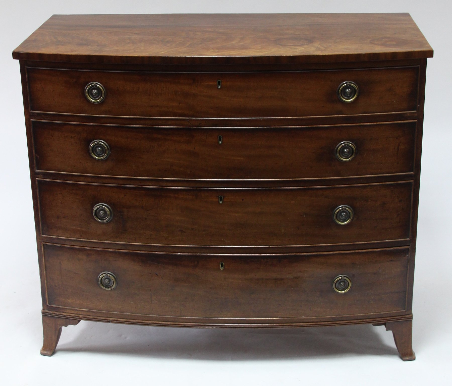 Appraisal: An early th Century mahogany bowfront chest fitted four long