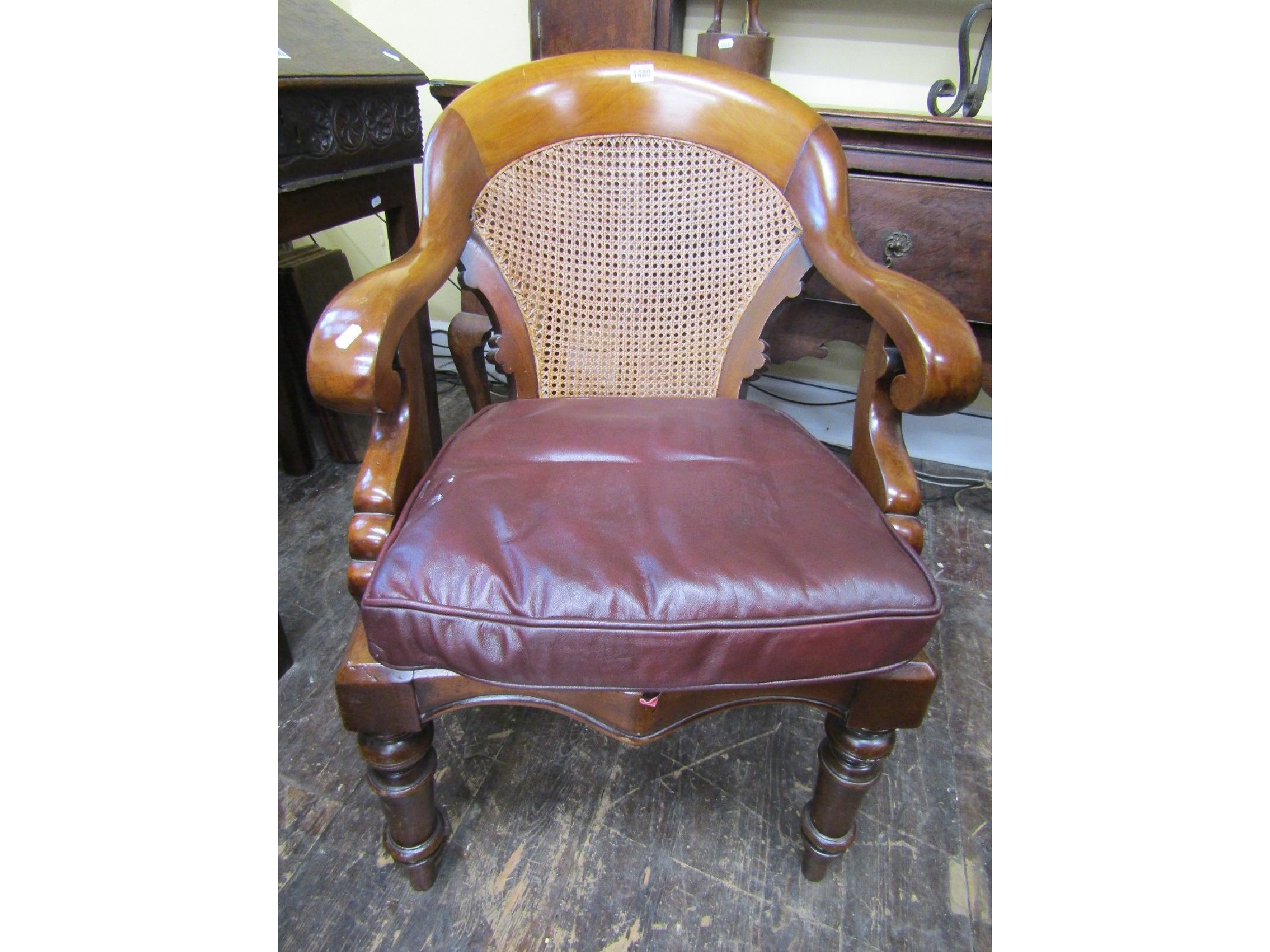 Appraisal: A mid- th century library chair with scrolled arms cane