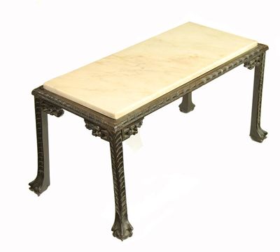 Appraisal: A rectangular mahogany side table with marble top the carved