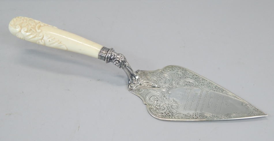 Appraisal: A silver presentation trowel with carved ivory handle the handle