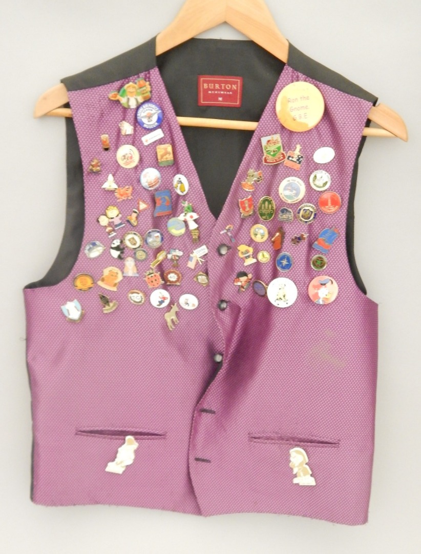 Appraisal: A waistcoat containing various gnome related badges etc